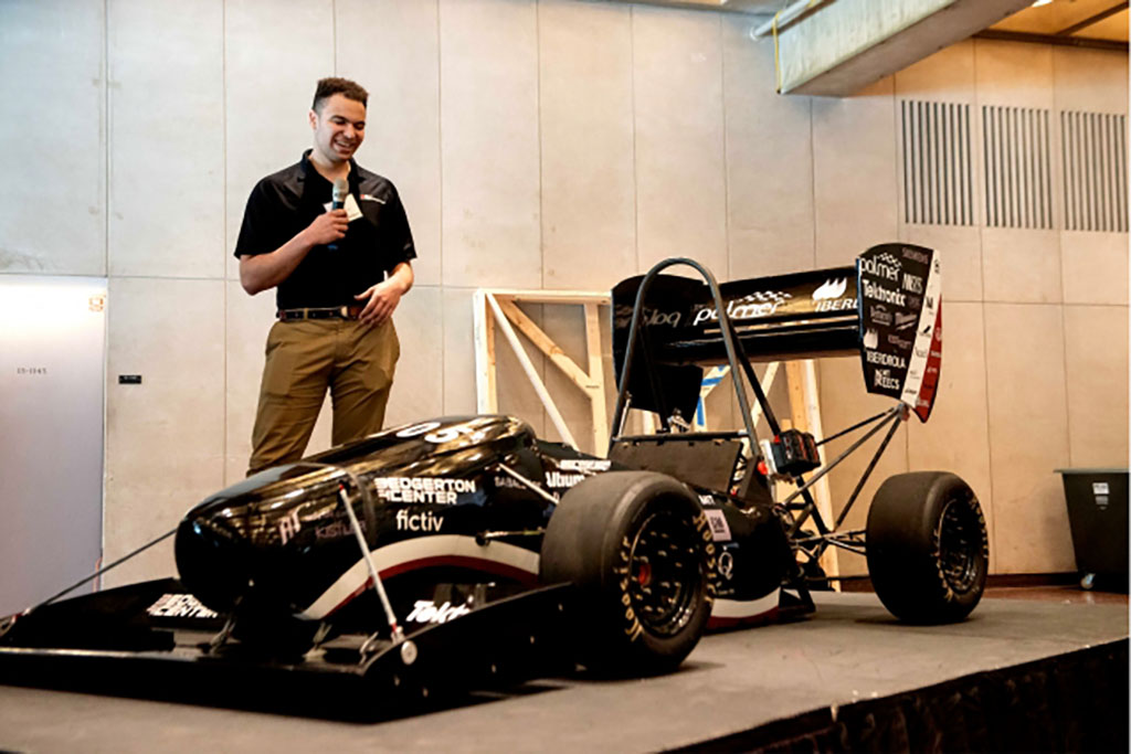 student on stage with car