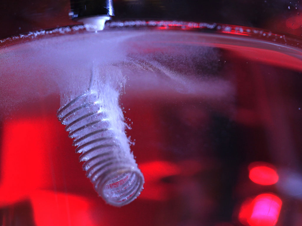 Inside liquid, a tightly coiled electrode makes tiny bubbles.