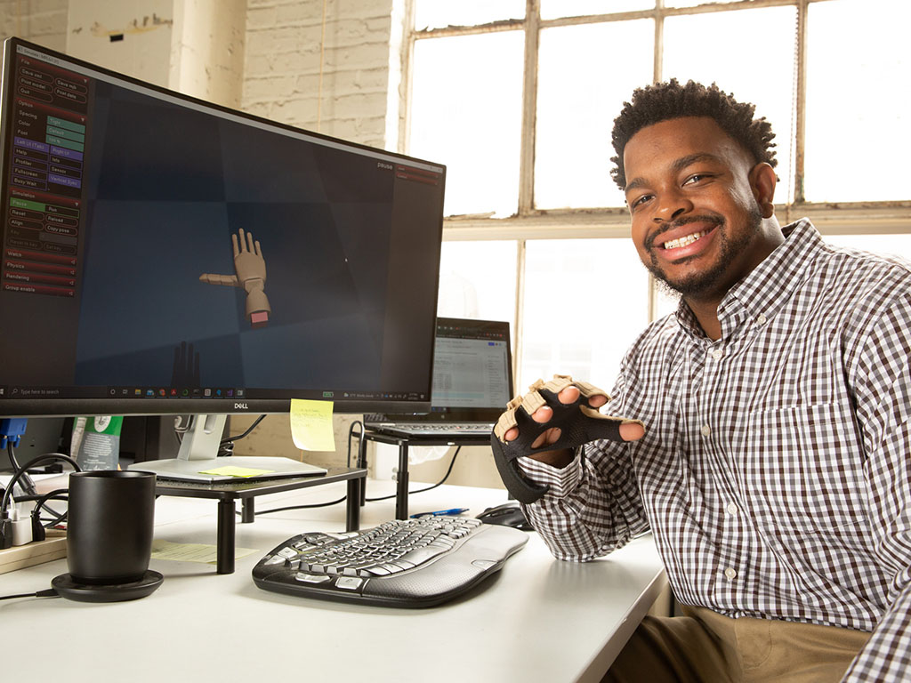 Michael West at computer with device